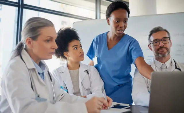 Healthcare team including RN and nurse practitioner discussing patient data